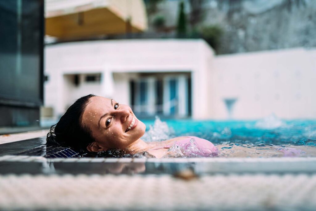 A lady enjoying health benefits in a hot tub