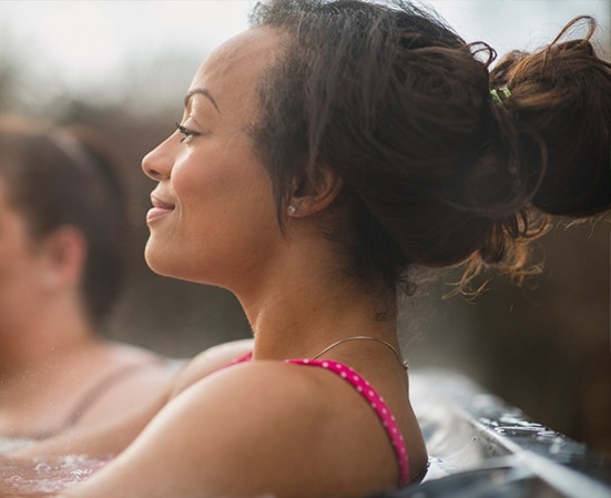 A lady is relaxing in a South Seas Spas hot tub