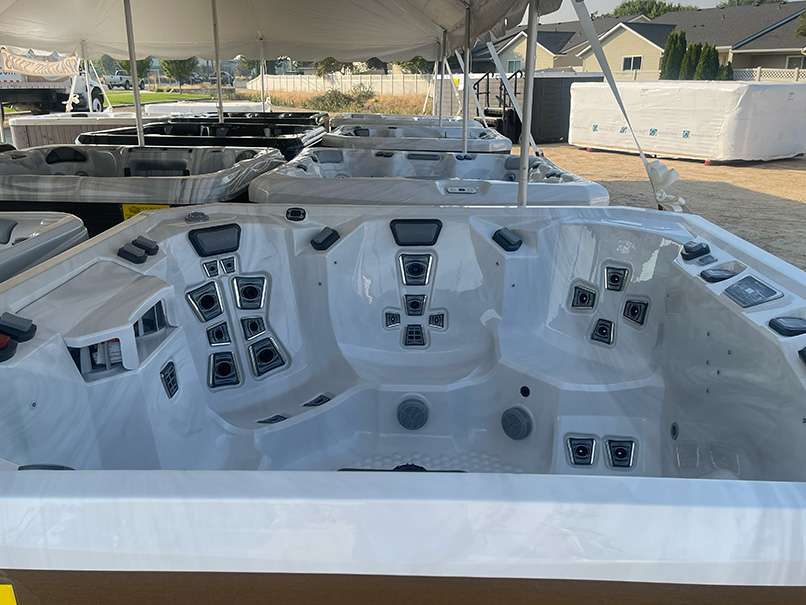 The-Best-Hot-Tub-Brands-A-Comprehensive-Comparison-for-Buyers-Artesian-Sas-A-Brand-You-Can-Trust - Love's Hot Tubs Rows of hot tubs for sale